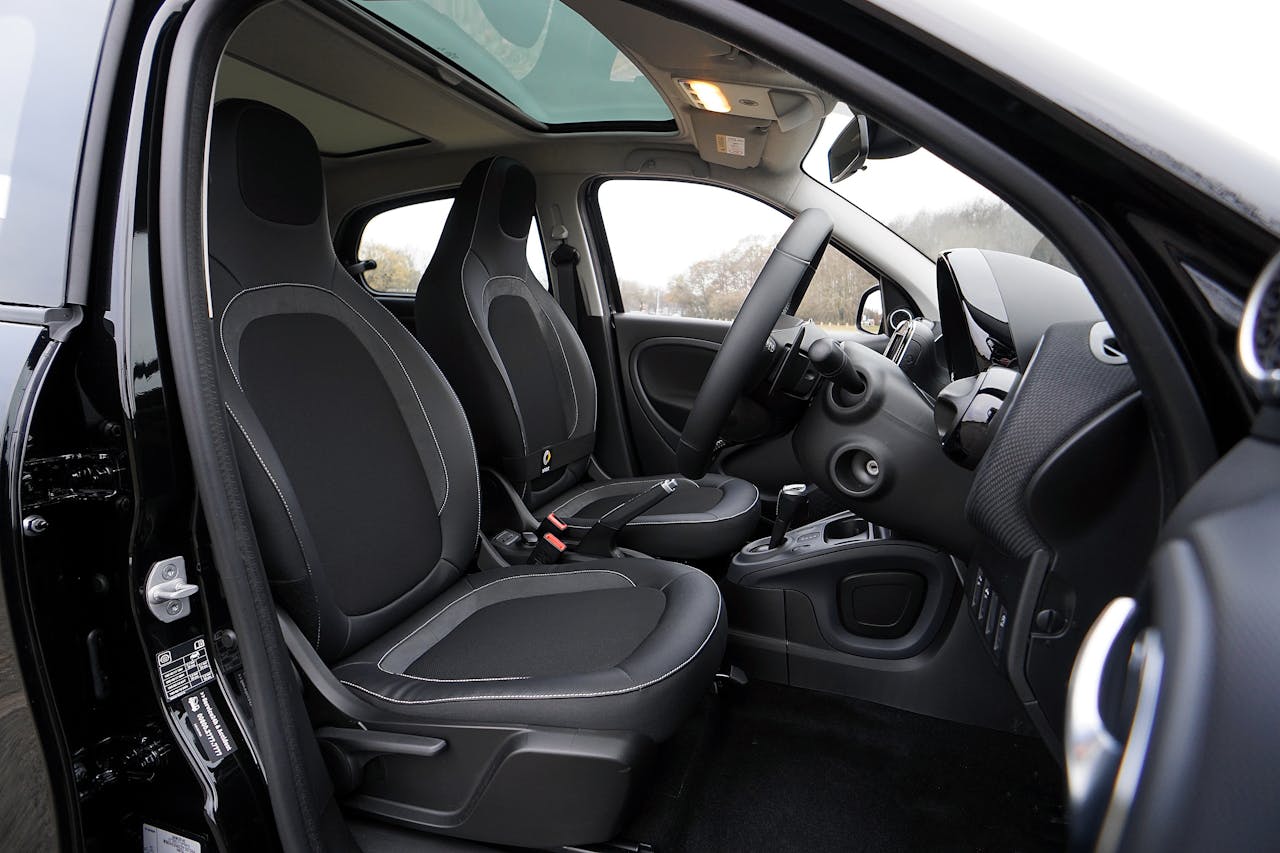 Explore a modern cars interior featuring black leather seats and advanced technology.